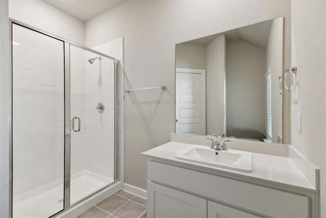 bathroom featuring vanity, baseboards, a shower stall, and tile patterned floors