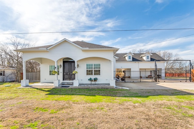 1932 Fm 36 S, Caddo Mills, TX 75135 - view of front facade with a gate, fence, a shingled roof, and a front yard
