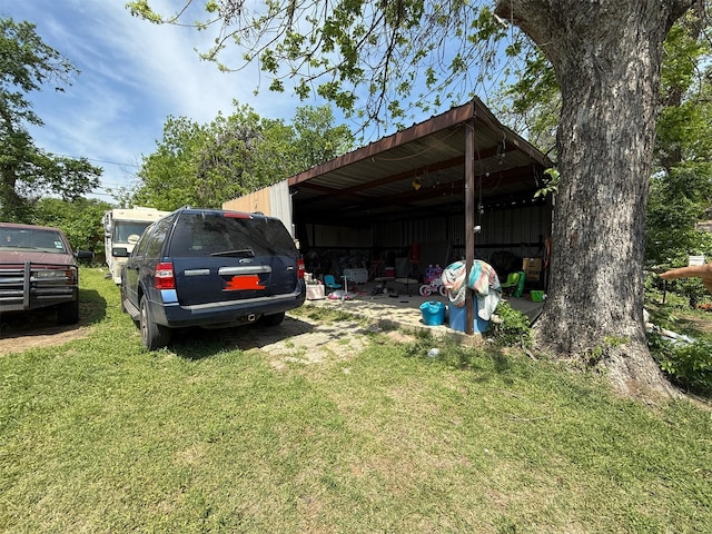 view of parking / parking lot featuring an outbuilding and a detached carport