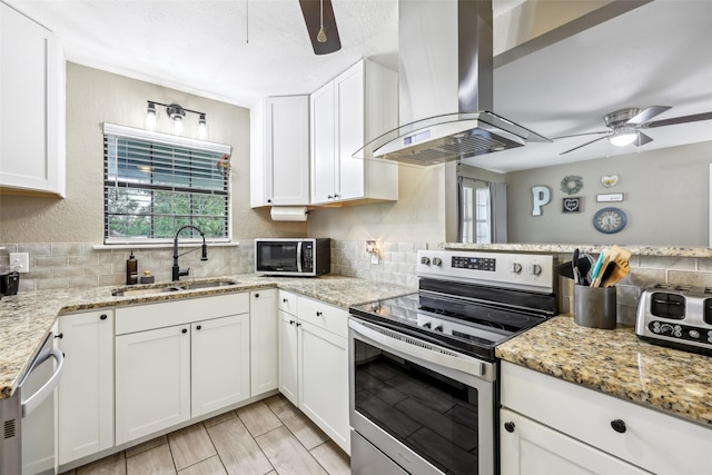 1015 Van Winkle St, Weatherford, TX 76086 - kitchen with appliances with stainless steel finishes, a sink, ceiling fan, and island exhaust hood