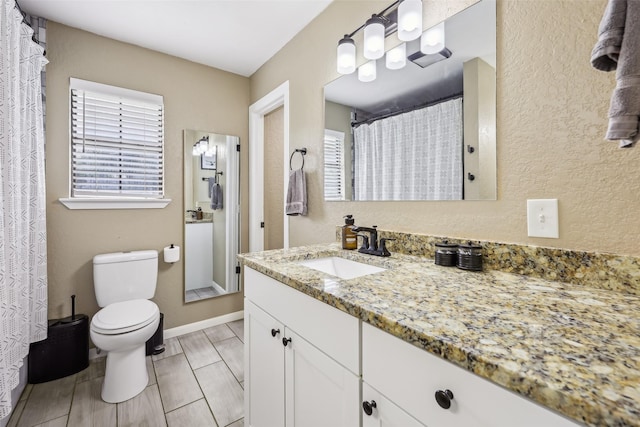 1015 Van Winkle St, Weatherford, TX 76086 - full bath featuring toilet, vanity, and curtained shower