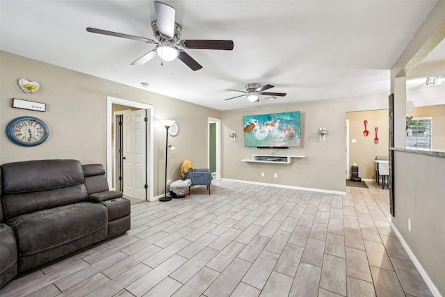 1015 Van Winkle St, Weatherford, TX 76086 - living area featuring a ceiling fan, light wood-style flooring, and baseboards