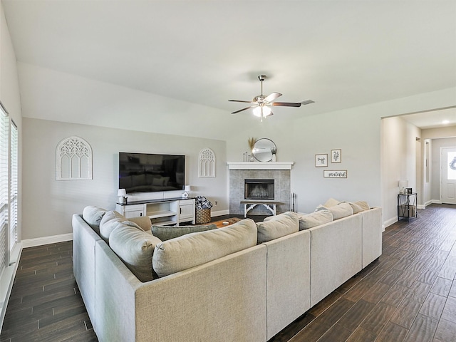 1455 Radecke Rd, Krum, TX 76249 - living room with baseboards, dark wood-style flooring, a ceiling fan, and a tile fireplace