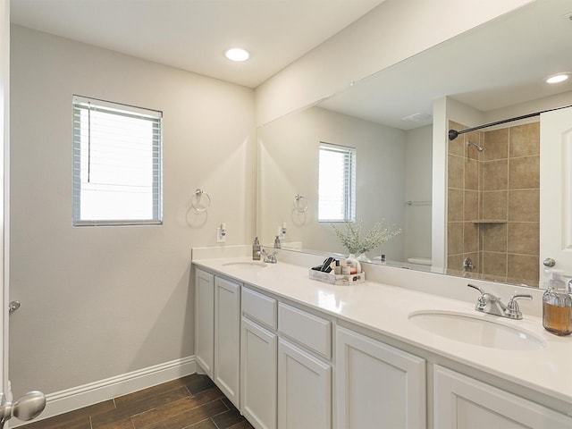1455 Radecke Rd, Krum, TX 76249 - bathroom featuring wood finished floors, double vanity, baseboards, a shower, and recessed lighting