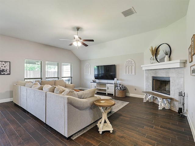 1455 Radecke Rd, Krum, TX 76249 - living room featuring vaulted ceiling, a ceiling fan, dark wood finished floors, baseboards, and a tiled fireplace