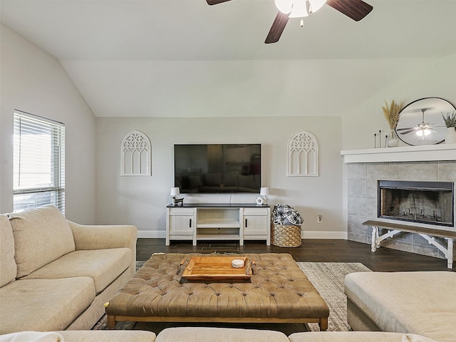 1455 Radecke Rd, Krum, TX 76249 - living room featuring ceiling fan, vaulted ceiling, baseboards, dark wood finished floors, and a tiled fireplace