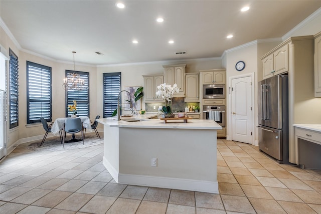 1305 Burgundy Ct, Southlake, TX 76092 - kitchen featuring appliances with stainless steel finishes, cream cabinetry, a sink, a chandelier, and light countertops