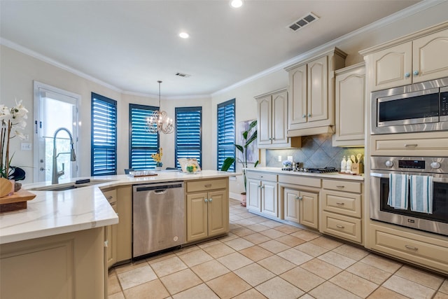 1305 Burgundy Ct, Southlake, TX 76092 - kitchen with appliances with stainless steel finishes, cream cabinets, a chandelier, a sink, and tasteful backsplash