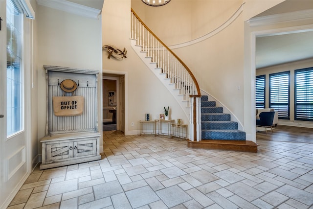 1305 Burgundy Ct, Southlake, TX 76092 - foyer entrance with stairway, stone tile flooring, ornamental molding, a towering ceiling, and baseboards