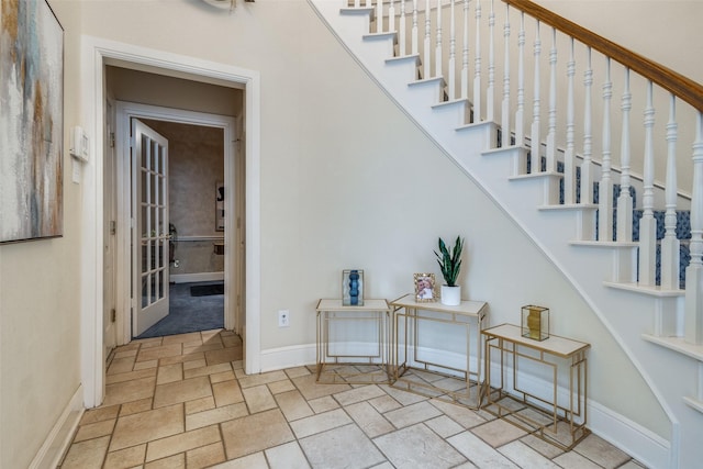 1305 Burgundy Ct, Southlake, TX 76092 - stairway featuring stone tile floors, baseboards, and french doors