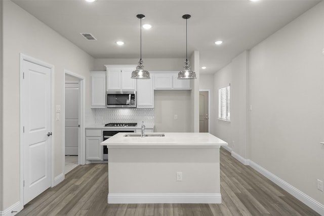 216 Griffith, Princeton, TX 75407 - kitchen featuring appliances with stainless steel finishes, a sink, light wood-style flooring, white cabinets, and decorative backsplash