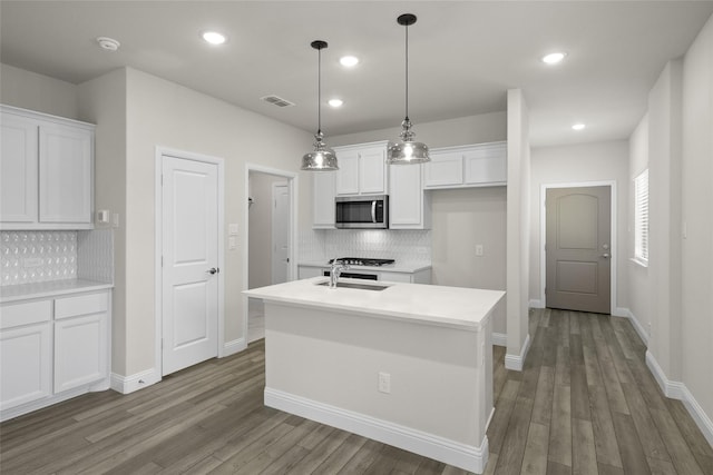 216 Griffith, Princeton, TX 75407 - kitchen with stainless steel microwave, white cabinetry, backsplash, and recessed lighting