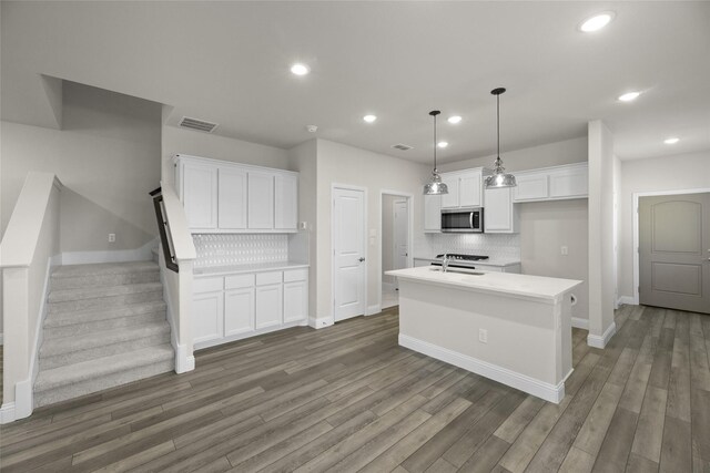 216 Griffith, Princeton, TX 75407 - kitchen with stainless steel microwave, tasteful backsplash, white cabinetry, a sink, and recessed lighting