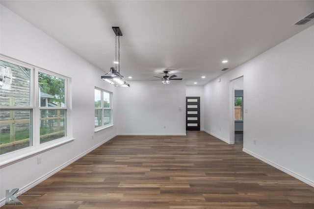 empty room featuring recessed lighting, visible vents, ceiling fan, and dark wood-type flooring