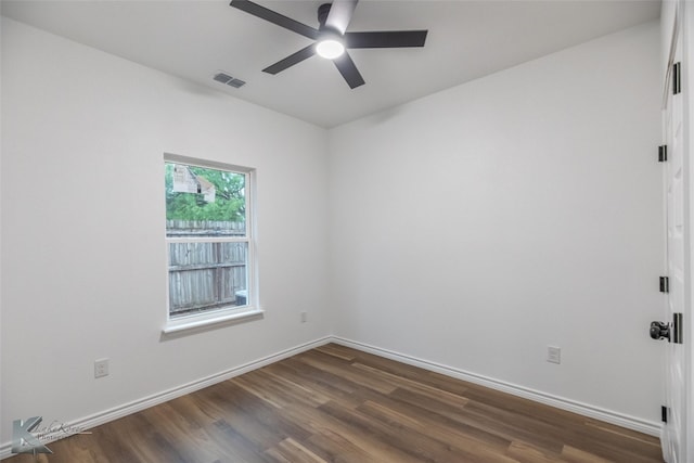 unfurnished room with visible vents, dark wood-style flooring, baseboards, and ceiling fan