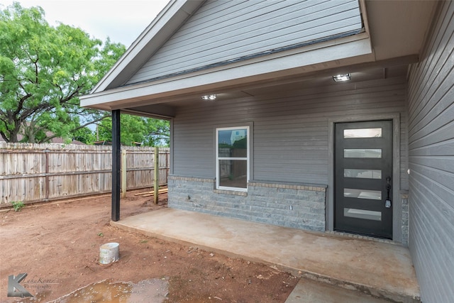 doorway to property with fence