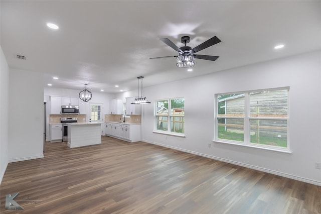 unfurnished living room featuring recessed lighting, visible vents, and wood finished floors