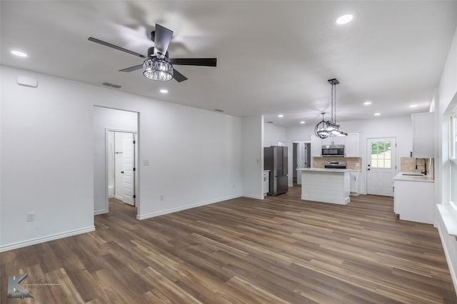 unfurnished living room with ceiling fan, recessed lighting, visible vents, and a sink