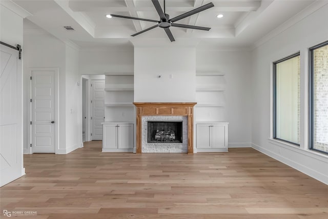 unfurnished living room with coffered ceiling, light wood-style floors, a ceiling fan, and crown molding