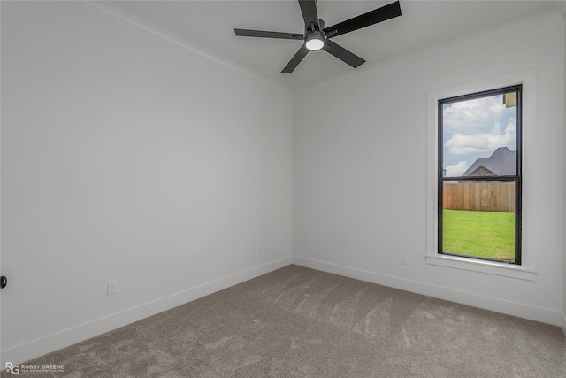 empty room featuring baseboards, ceiling fan, crown molding, and carpet floors