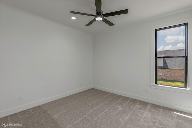 unfurnished room with ornamental molding, light carpet, and baseboards