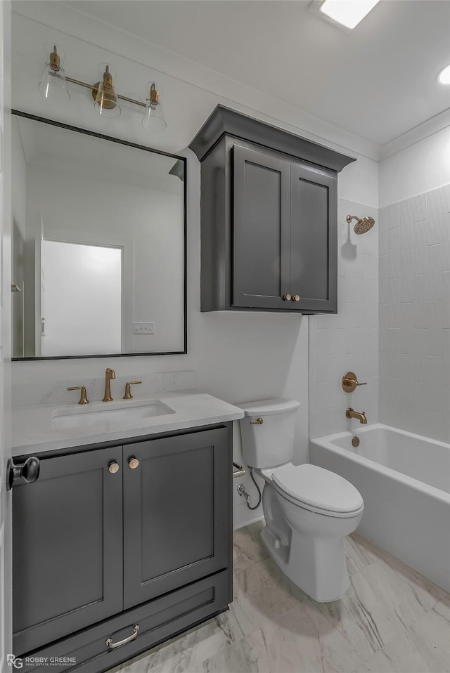 bathroom with toilet, marble finish floor, vanity, and shower / washtub combination