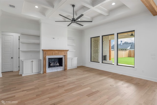 unfurnished living room with beamed ceiling, visible vents, and light wood-style floors