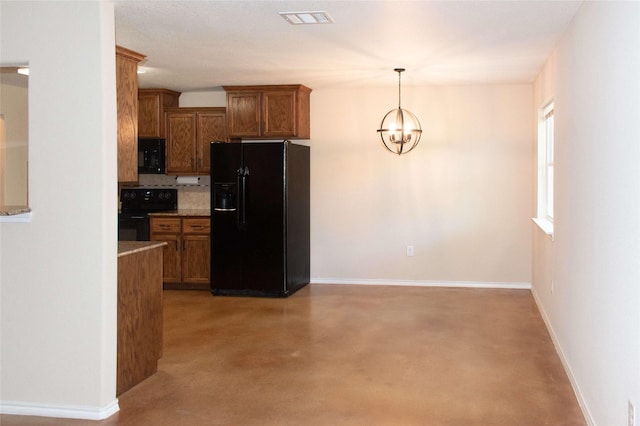 kitchen featuring brown cabinetry, visible vents, a chandelier, black appliances, and concrete flooring