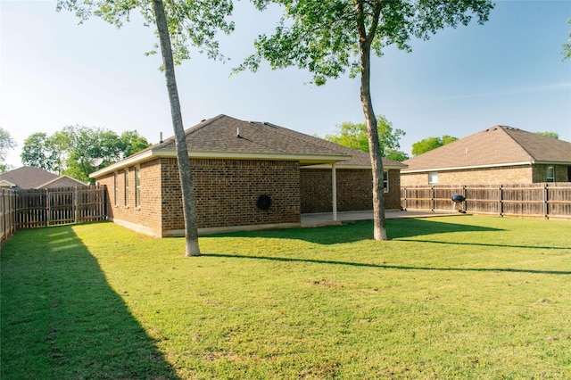 view of yard with a fenced backyard and a patio