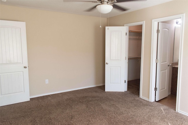 unfurnished bedroom with carpet, a closet, and a spacious closet
