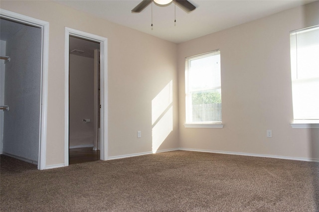 unfurnished bedroom with baseboards, carpet flooring, and a ceiling fan