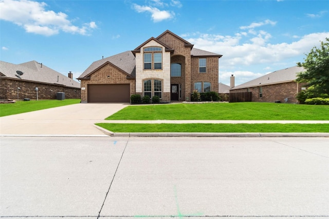 1112 Crest Ridge Dr, Glenn Heights, TX 75154 - view of front of home with a front yard, driveway, a garage, stone siding, and brick siding