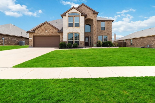 1112 Crest Ridge Dr, Glenn Heights, TX 75154 - view of front of house with concrete driveway, an attached garage, brick siding, central air condition unit, and stone siding