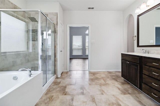 1112 Crest Ridge Dr, Glenn Heights, TX 75154 - full bathroom with vanity, a bath, a shower stall, and baseboards