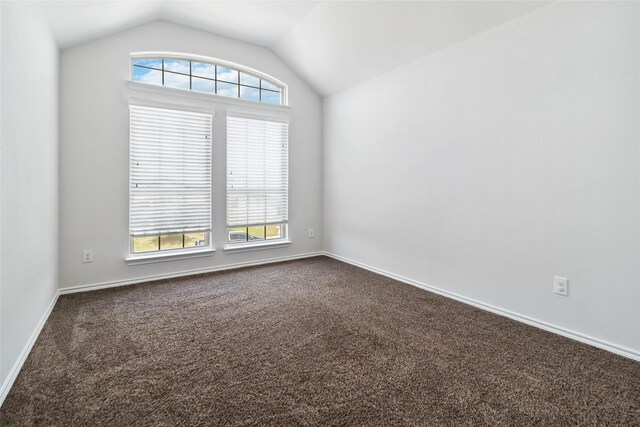 1112 Crest Ridge Dr, Glenn Heights, TX 75154 - spare room with dark carpet, lofted ceiling, healthy amount of natural light, and baseboards
