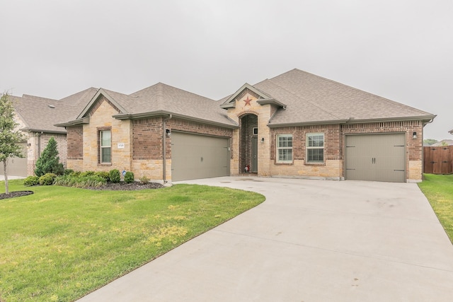 1725 Bellatrix Dr, Haslet, TX 76052 - view of front of property featuring a garage, roof with shingles, a front yard, brick siding, and driveway