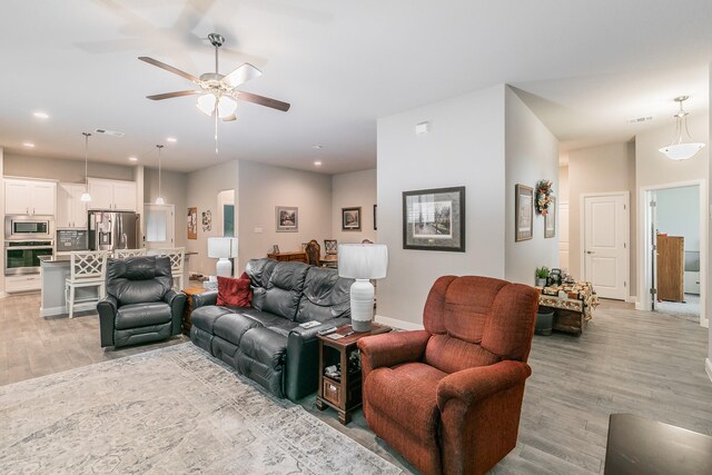 1725 Bellatrix Dr, Haslet, TX 76052 - living room featuring visible vents, recessed lighting, light wood-style flooring, a ceiling fan, and baseboards
