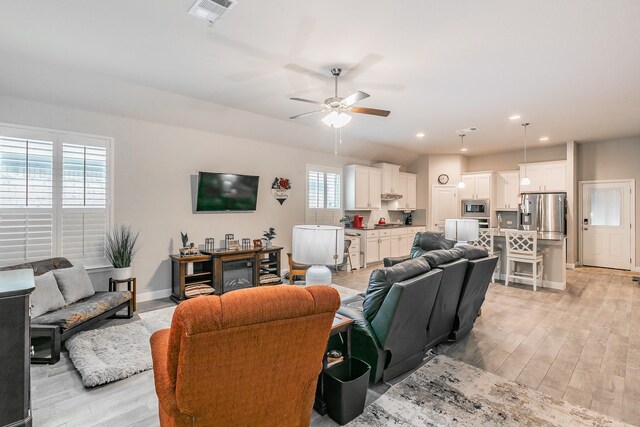1725 Bellatrix Dr, Haslet, TX 76052 - living room featuring light wood-style flooring, a ceiling fan, visible vents, baseboards, and recessed lighting