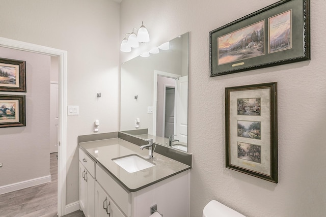 1725 Bellatrix Dr, Haslet, TX 76052 - bathroom with toilet, baseboards, wood finished floors, and vanity