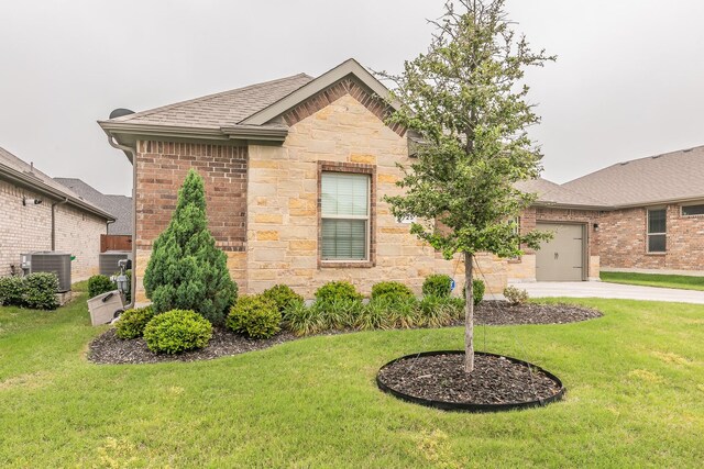 1725 Bellatrix Dr, Haslet, TX 76052 - view of front of house with an attached garage, central air condition unit, a front yard, stone siding, and concrete driveway