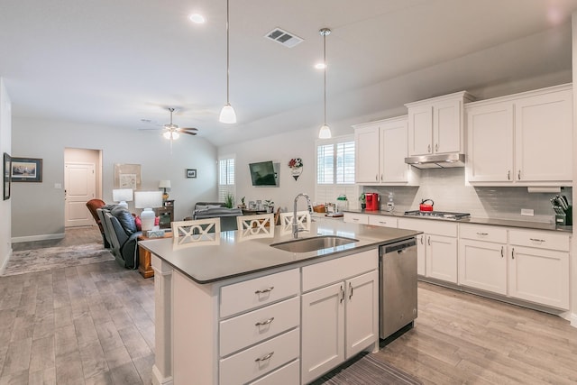 1725 Bellatrix Dr, Haslet, TX 76052 - kitchen with under cabinet range hood, visible vents, a sink, decorative backsplash, and stainless steel appliances