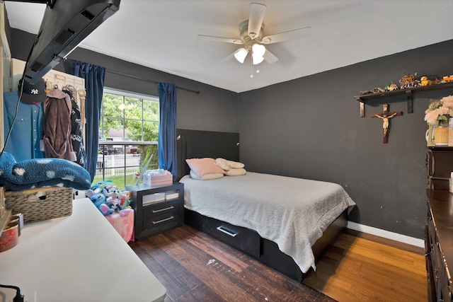 7810 Maxwell Ave, Dallas, TX 75217 - bedroom with baseboards, dark wood finished floors, and a ceiling fan