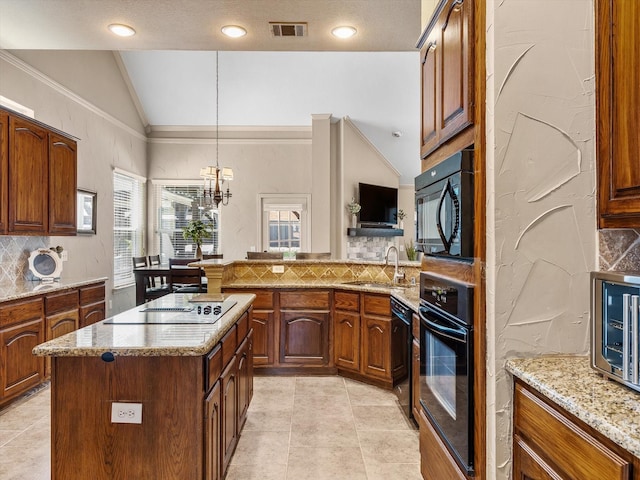 kitchen with visible vents, a sink, vaulted ceiling, black appliances, and tasteful backsplash