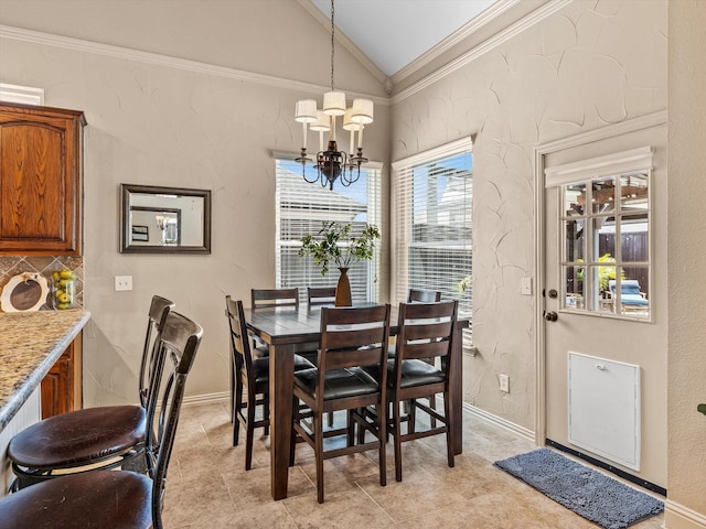 dining space with vaulted ceiling, a chandelier, ornamental molding, and baseboards