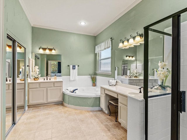 bathroom with ornamental molding, a bath, two vanities, tile patterned flooring, and recessed lighting