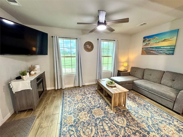 124 Oakwood St, Chico, TX 76431 - living area with visible vents, wood finished floors, baseboards, and ceiling fan