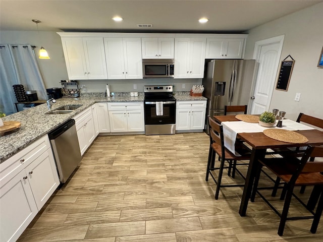 124 Oakwood St, Chico, TX 76431 - kitchen with recessed lighting, white cabinetry, stainless steel appliances, and a sink