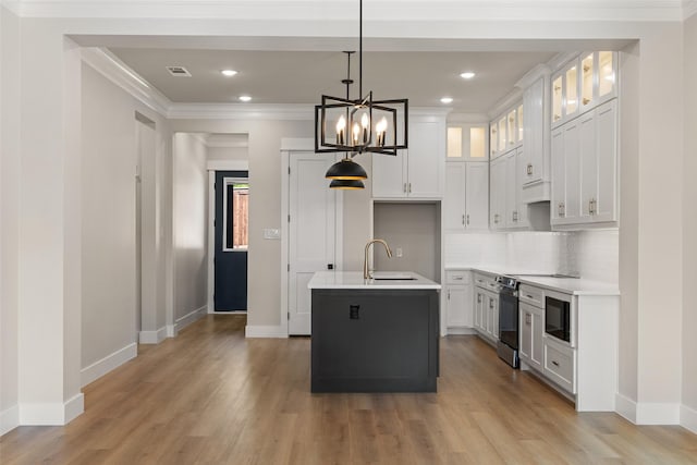 kitchen featuring baseboards, light wood-type flooring, stainless steel electric range, and a sink