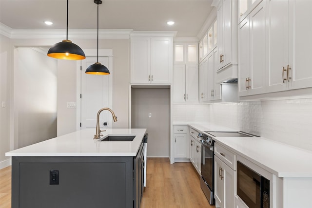 kitchen with light wood-style flooring, electric range oven, a sink, black microwave, and white cabinets