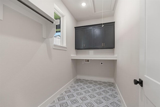 laundry room with cabinet space, attic access, hookup for an electric dryer, hookup for a washing machine, and baseboards